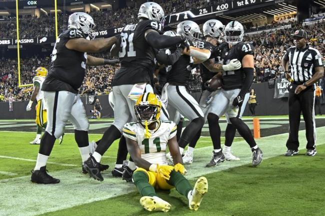 Las Vegas Raiders' Robert Spillane is co<em></em>ngratulated after his interception during the first half of an NFL football game against the Green Bay Packers Monday, Oct. 9, 2023, in Las Vegas. (AP Photo/David Becker)