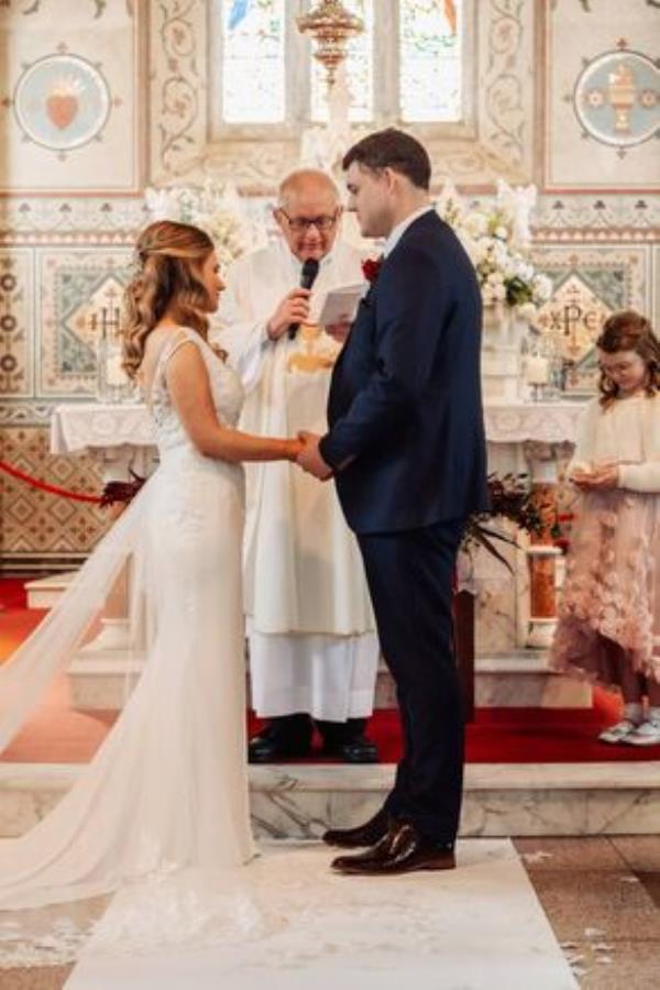 Noreen Loo<em></em>ney and Niall Drumm with Fr Danny Broderick. Pictures: Tara Do<em></em>noghue Photography