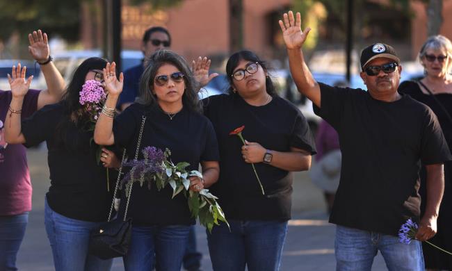 Alfredo Pelaez, right, prays for his brother David Pelaez-Chavez with his family, from left, Yaranaxali Pelaez, Aurora Castro and Nayceht Pelaez, during a vigil Saturday, July 29, 2023 at Old Courthouse Square in Santa Rosa. The vigil marked one year since Pelaez-Chavez was shot and killed by a So<em></em>noma County Sheriff’s deputy.  (Kent Porter / The Press Democrat) 2023