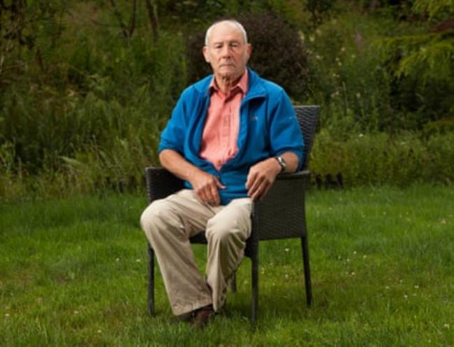 Marcus Bailie, 68, sitting on a chair in his garden